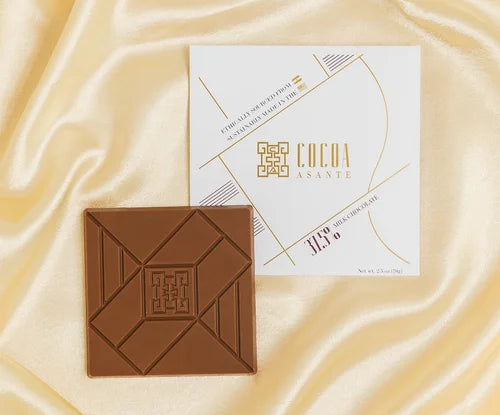 Chocolate bar with a branded packaging  from Cocoal Asante on a satin surface