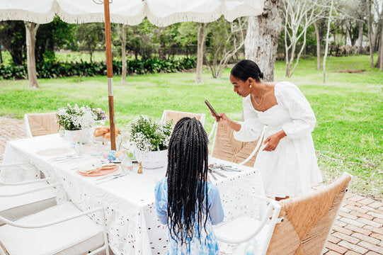 Mother and daughter preparing for a n afternoon tea eagerly anticipating friends to enjoy and afternoon of tea