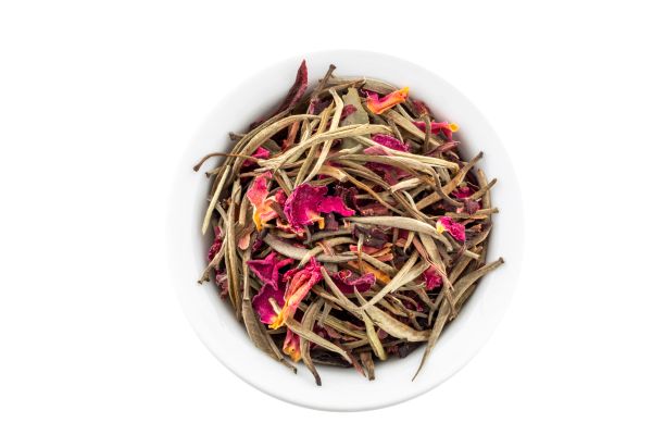 Bai Long Xu White Tea, blended with dehydrated roses and lavender, in a white bowl.