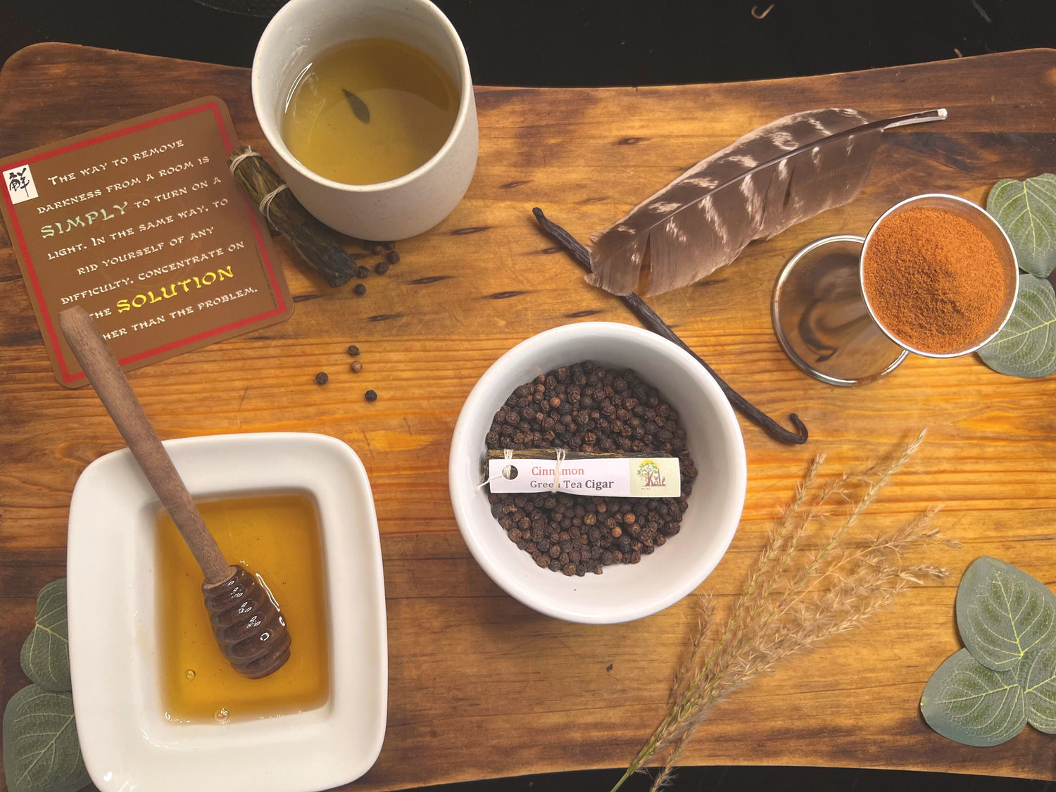 Tea Cigar on a wood board, next to bowl of honey