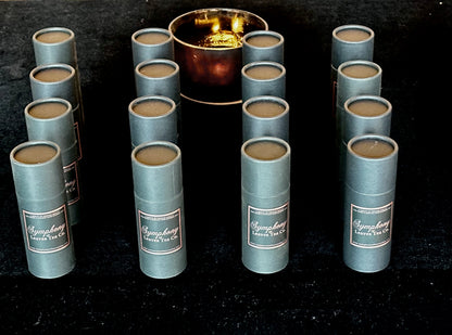 Symphony of Leaves branded tea canisters with candle in the background