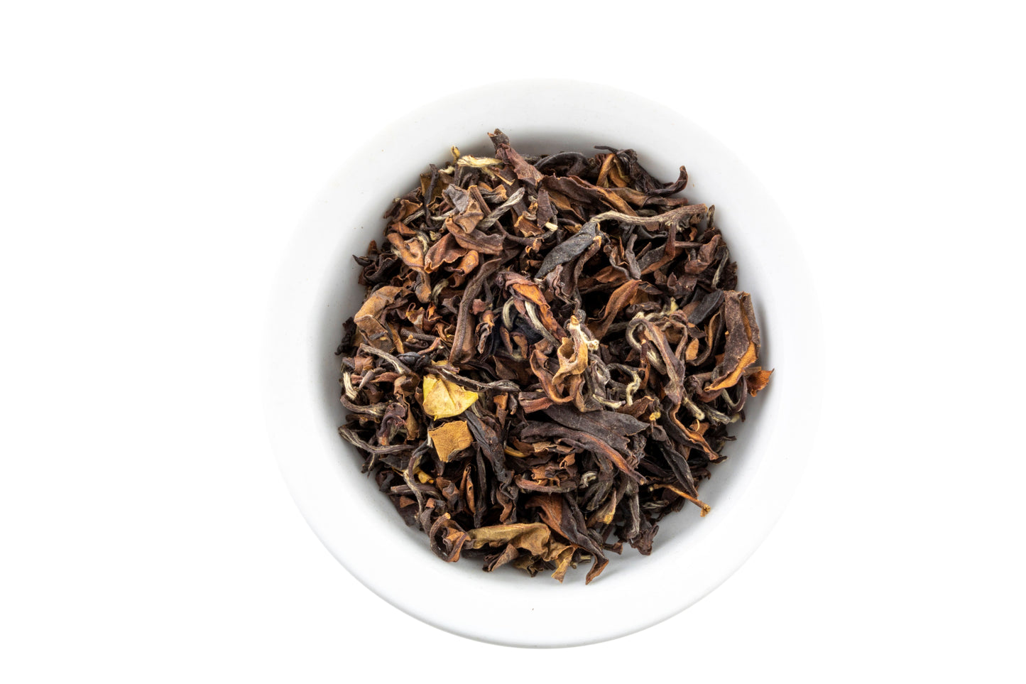 Dry premium oolong tea leaves in a white bowl on a white background