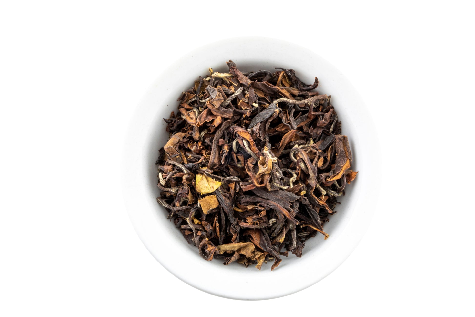 Dry premium oolong tea leaves in a white bowl on a white background