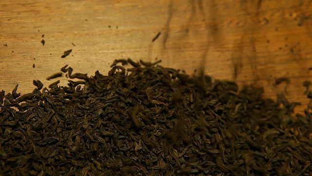 Close-up of dried Darjeeling black tea leaves on a wooden surface