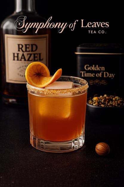 Golden Time of Day tea–infused Red Hazel whiskey cocktail with dried orange garnish, photographed against a black background with the Symphony of Leaves Tea Co. logo and loose-leaf tea