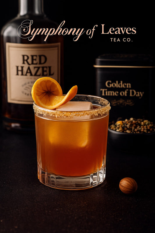 Golden Time of Day tea–infused Red Hazel whiskey cocktail with dried orange garnish, photographed against a black background with the Symphony of Leaves Tea Co. logo and loose-leaf tea