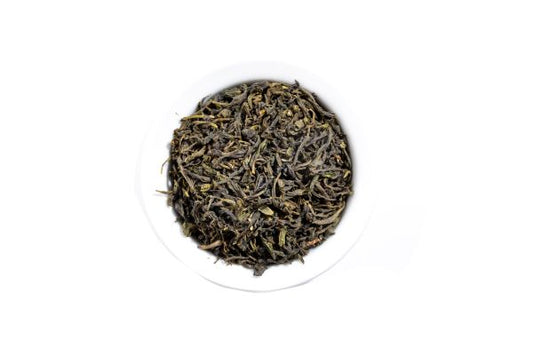 Loose leaf Chinese green tea on a white background