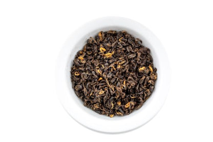 Nepali loose oolong tea leaves in a white bowl on a white background