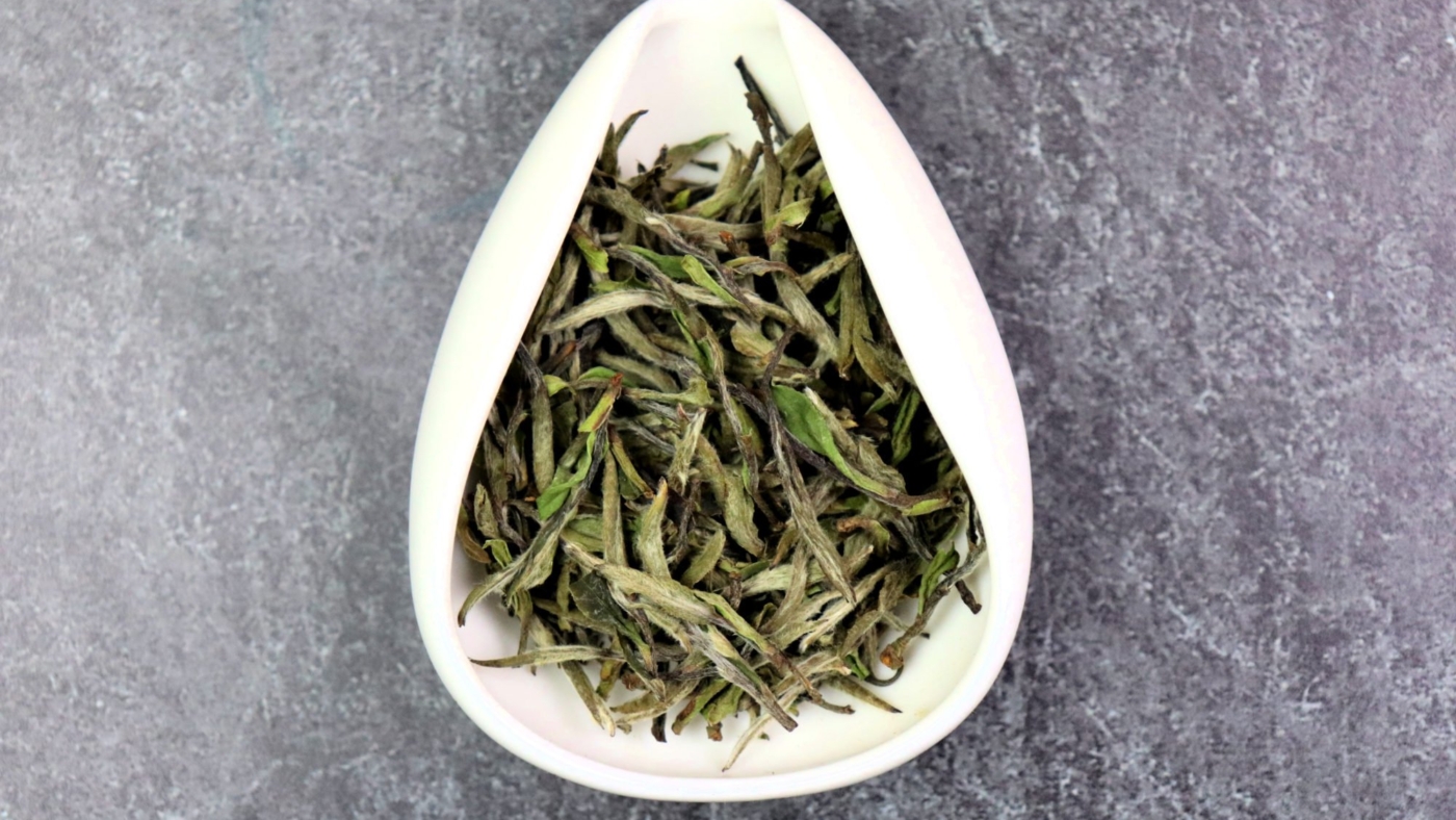 Dried white tea leaves in a bowl