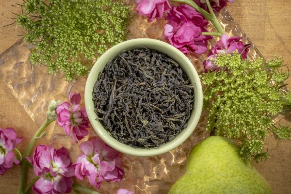 Green tea leaves with pink flowers and pear