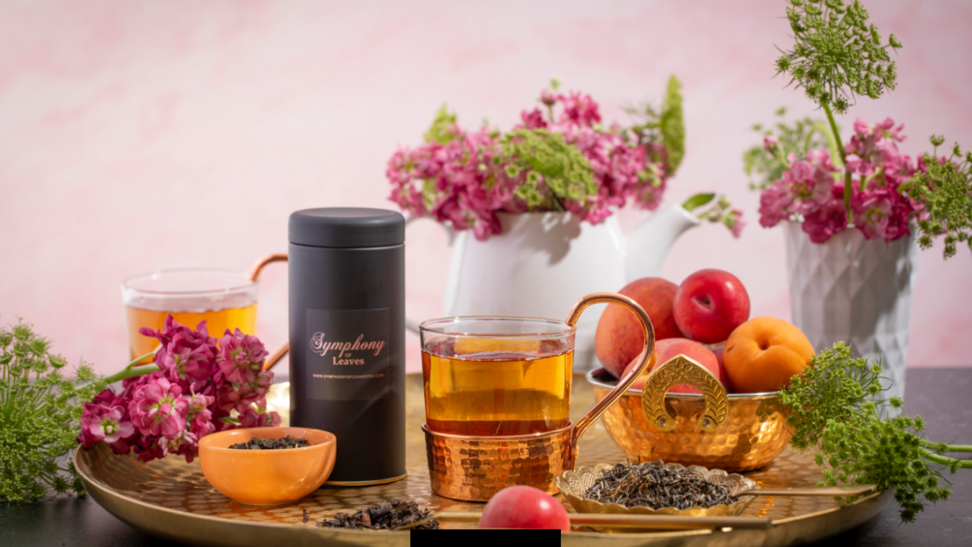 Elegant tea set with fresh flowers and fruit