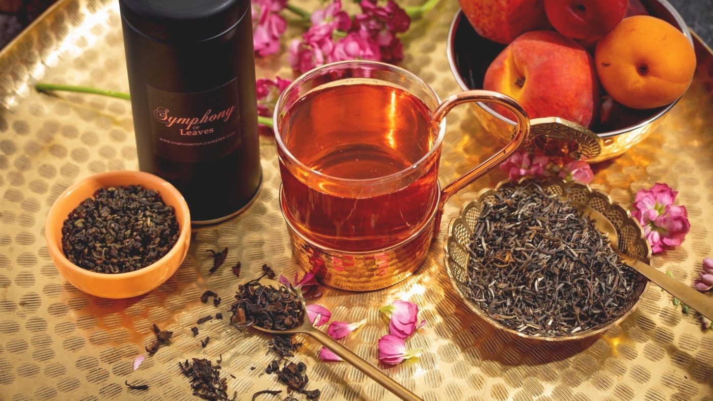 Tea with dried leaves and fresh fruit.