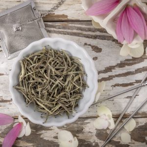 White tea leaves in a white bowl