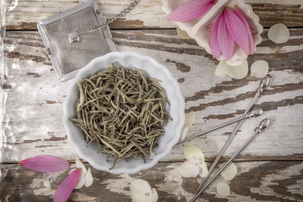 White tea leaves in a white bowl