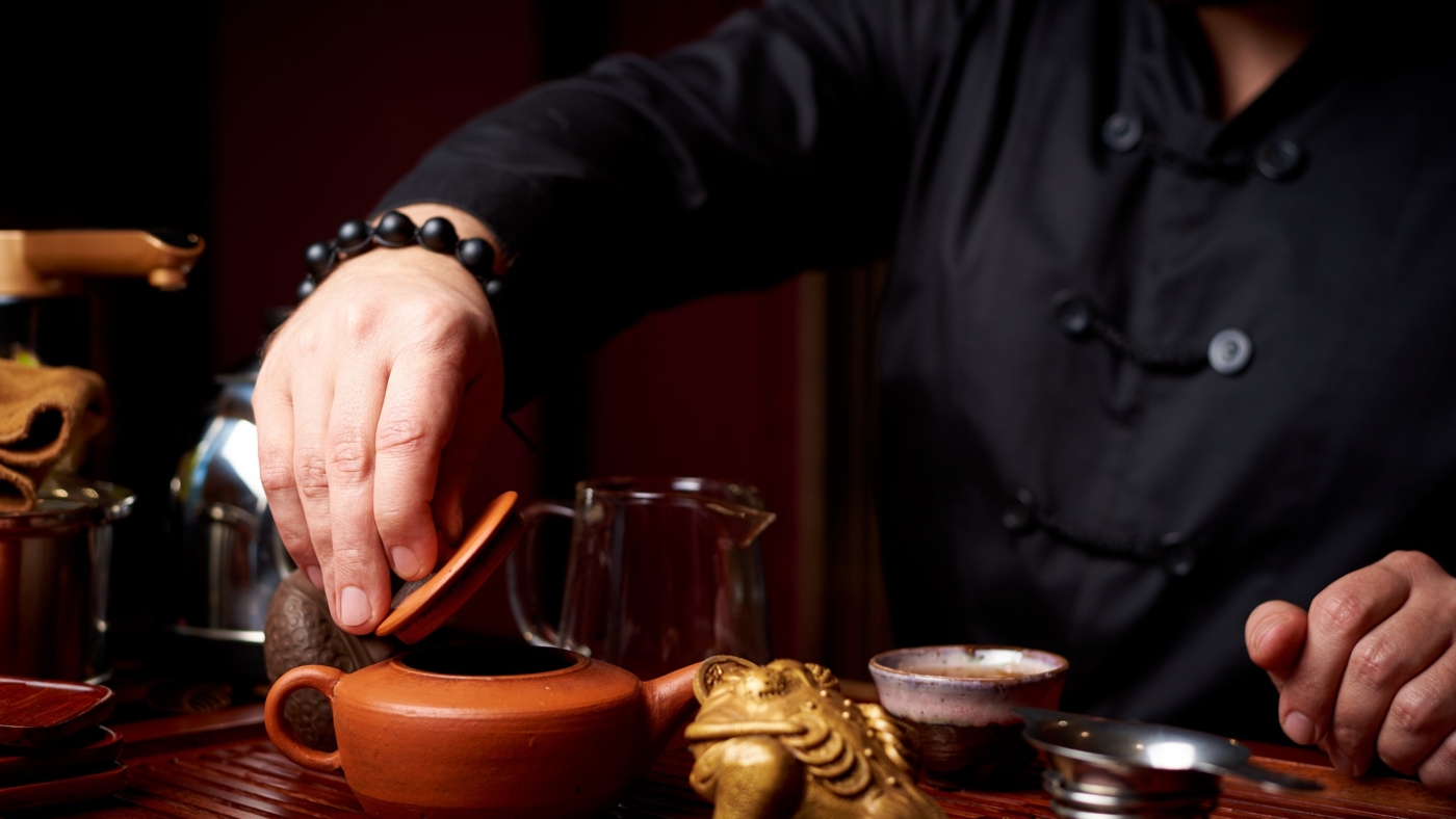 Person preparing traditional Chinese tea ceremony.