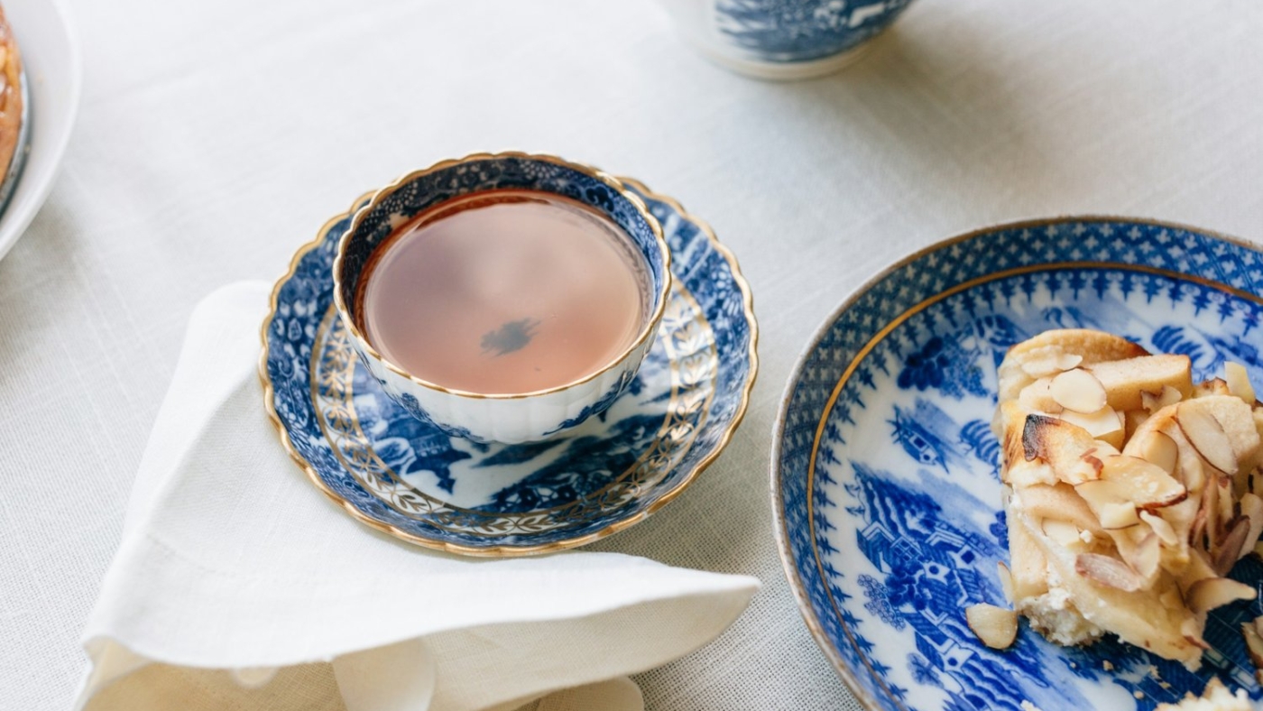 Tea in blue china cup with dessert.