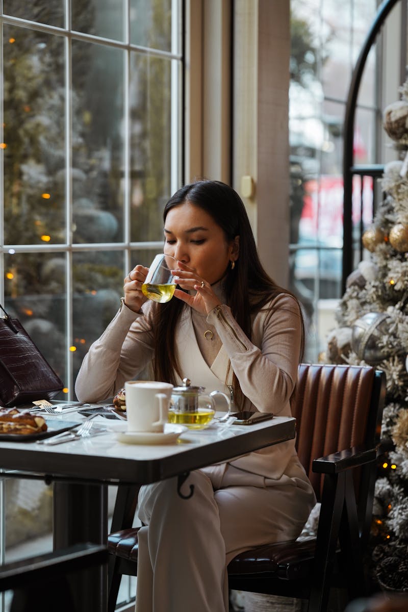 Woman enjoying tea in cozy winter cafe