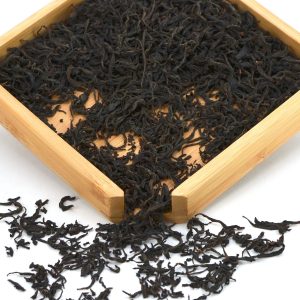 Loose leaf black tea in wooden tray