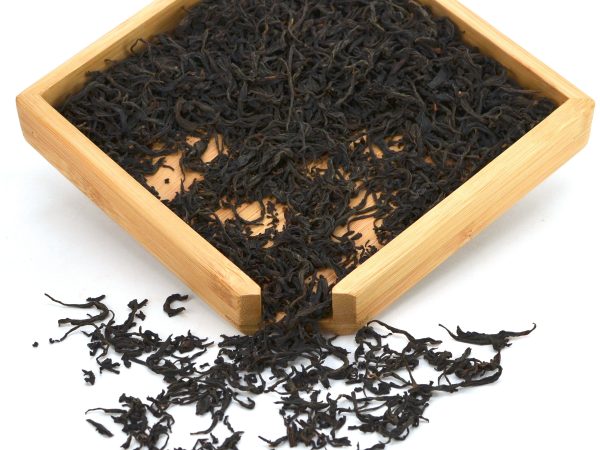 Loose leaf black tea in wooden tray