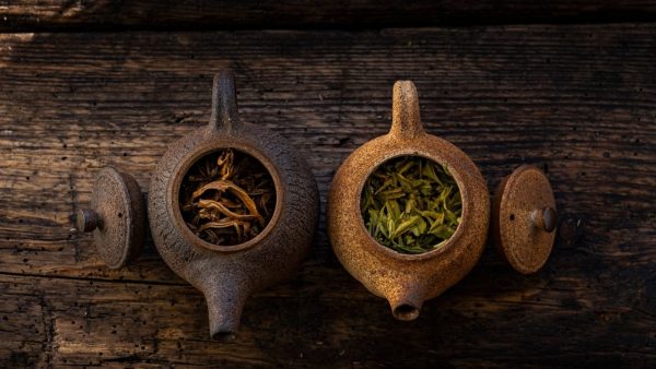 Two rustic teapots with loose leaf tea