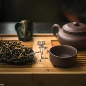 Traditional tea set with dried tea leaves