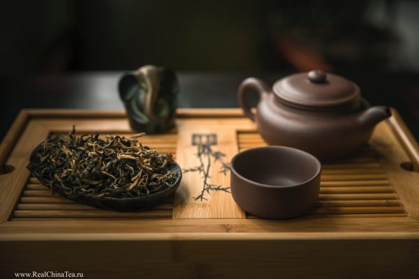 Traditional tea set with dried tea leaves