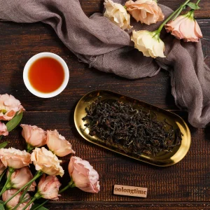 Tea and flowers on dark wooden table