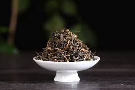 Loose leaf oolong tea in white dish