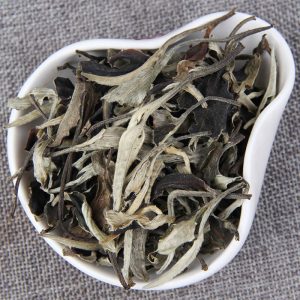 White tea leaves in a ceramic bowl